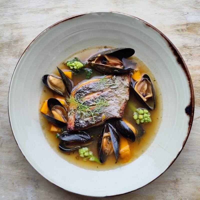 Linecaught sea bass with mussels, seasonal vegetables and a spicy